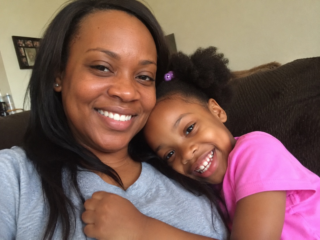 A mother and daughter smiling together